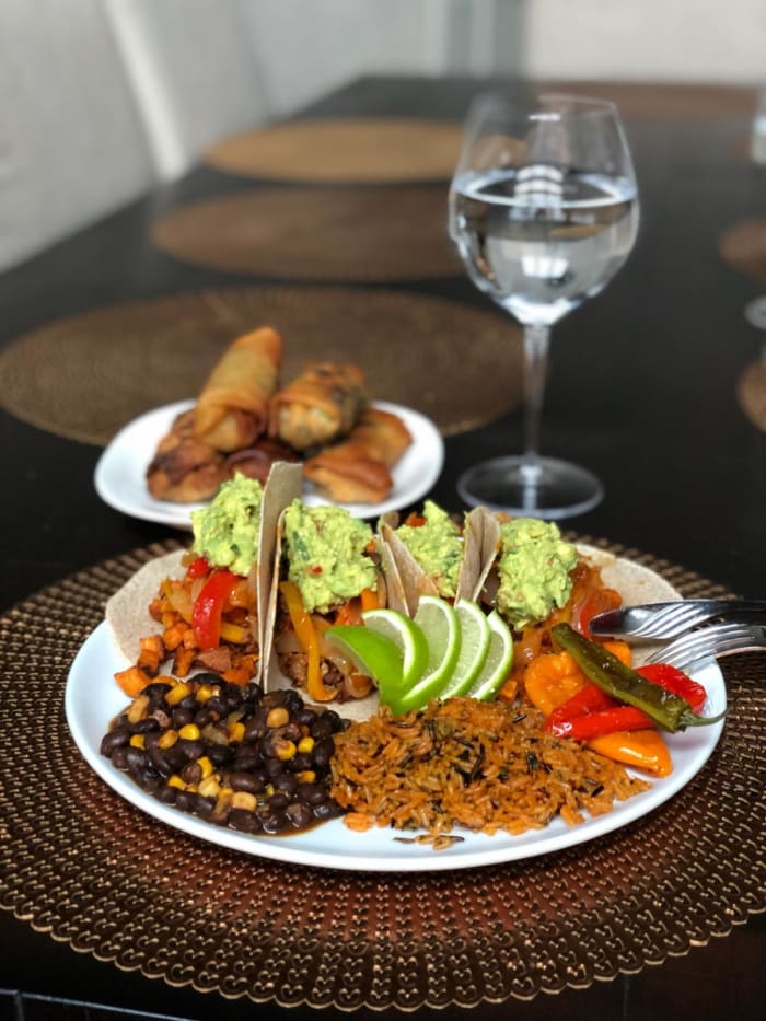 A plate of sweet potato tacos, rice and beans